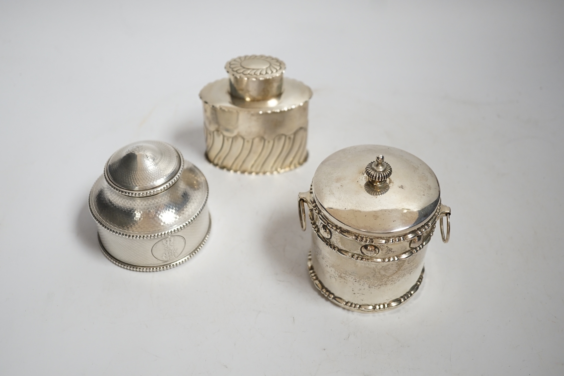 A Victorian engine turned silver circular tea caddy, William Shaw II, London, 1865, height 68mm, together with two other silver tea caddies, 14.8oz.